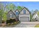 Charming two-story home featuring a stone facade, arched windows, and well-maintained landscaping at 1363 Brentwood Ln, Marietta, GA 30062