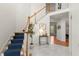 A beautiful foyer with marble floors and a staircase with blue carpet at 1363 Brentwood Ln, Marietta, GA 30062