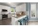 Stylish kitchen with a breakfast bar, modern appliances, and ample natural light from surrounding windows at 1363 Brentwood Ln, Marietta, GA 30062