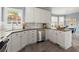 Bright kitchen featuring white cabinets, stainless steel appliances, modern lighting, and a breakfast nook at 1363 Brentwood Ln, Marietta, GA 30062