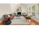 Bright living room with a fireplace, hardwood floors and expansive windows with natural light at 1363 Brentwood Ln, Marietta, GA 30062
