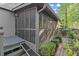 Cozy screened-in porch with steps and ramp that leads to a walkway surrounded by shrubs at 1363 Brentwood Ln, Marietta, GA 30062