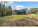 Expansive backyard view showcases lush greenery, mature trees, and a charming home exterior at 1612 Sky Crest Dr, Lithia Springs, GA 30122