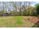Wide backyard with green grass features mature trees, open spaces and attractive landscaping at 1612 Sky Crest Dr, Lithia Springs, GA 30122