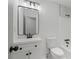 Modern bathroom features a new white vanity, mirror, and new tile in the shower at 1612 Sky Crest Dr, Lithia Springs, GA 30122