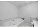 Modern bathroom features a soaking tub with marble tile, updated fixtures, and toilet at 1612 Sky Crest Dr, Lithia Springs, GA 30122