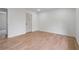 Bedroom with laminate flooring, white trim, and a connecting doorway at 1612 Sky Crest Dr, Lithia Springs, GA 30122