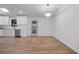 Modern dining area with wood floors, open to kitchen, and a stylish chandelier at 1612 Sky Crest Dr, Lithia Springs, GA 30122