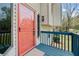 Close up of front entry showing colorful door, and blue porch with rails at 1612 Sky Crest Dr, Lithia Springs, GA 30122