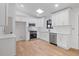 Bright kitchen features stainless appliances, white cabinets and subway tile backsplash at 1612 Sky Crest Dr, Lithia Springs, GA 30122