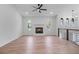 Spacious living room featuring a stone fireplace, unique windows, and light wood floors at 1612 Sky Crest Dr, Lithia Springs, GA 30122