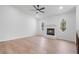 Bright living room with a stone fireplace, ceiling fan, and light wood flooring at 1612 Sky Crest Dr, Lithia Springs, GA 30122
