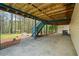 Spacious covered patio features a concrete floor, wooden stairs, and access to the backyard at 1612 Sky Crest Dr, Lithia Springs, GA 30122