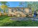 Exterior view of the backyard featuring a small patio, green grass, and backyard entrance at 2070 Perkerson Sw Rd, Atlanta, GA 30310