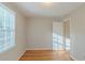 Sunlit bedroom with hardwood floors, fresh paint, and a view from the window at 2070 Perkerson Sw Rd, Atlanta, GA 30310