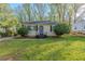 Charming single-story home featuring a well-maintained lawn and mature landscaping at 2070 Perkerson Sw Rd, Atlanta, GA 30310