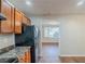 Kitchen with wood cabinets and black appliances overlooking an open area at 2070 Perkerson Sw Rd, Atlanta, GA 30310