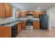 Well-equipped kitchen with wood cabinets, black appliances, and durable countertops at 2070 Perkerson Sw Rd, Atlanta, GA 30310