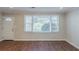 Living room features wood-look flooring, crown molding, and large window for natural light at 2070 Perkerson Sw Rd, Atlanta, GA 30310