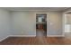 Open living room with wood-look floors and a view into the kitchen and other rooms at 2070 Perkerson Sw Rd, Atlanta, GA 30310