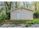Exterior view of a detached storage shed with a door and siding at 2070 Perkerson Sw Rd, Atlanta, GA 30310