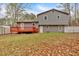 Exterior of a two-story home with a wooden back deck and a spacious backyard with lawn at 3640 Silver Leaf Sw Ln, Marietta, GA 30008