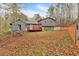 Back exterior view of house with playhouse in yard and lush green trees and wooden deck at 3640 Silver Leaf Sw Ln, Marietta, GA 30008