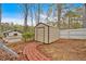 Backyard with metal shed, brick pathway, and a white fence offers outdoor storage at 3640 Silver Leaf Sw Ln, Marietta, GA 30008