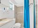 Bathroom features a single sink vanity and a walk-in shower with blue shower curtain and tiled wall at 3640 Silver Leaf Sw Ln, Marietta, GA 30008