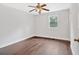 Inviting bedroom with hardwood floors, a ceiling fan, and natural light from a large window at 3640 Silver Leaf Sw Ln, Marietta, GA 30008