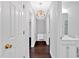 Hallway features dark hardwood floors and a modern light fixture at 3640 Silver Leaf Sw Ln, Marietta, GA 30008