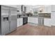 Spacious kitchen with stainless steel appliances, white cabinetry and tile backsplash at 3640 Silver Leaf Sw Ln, Marietta, GA 30008