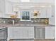 Bright kitchen showcasing white cabinets, stainless steel appliances, and decorative details at 3640 Silver Leaf Sw Ln, Marietta, GA 30008
