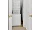 Efficient laundry area featuring a stacked washer and dryer for space-saving convenience at 3640 Silver Leaf Sw Ln, Marietta, GA 30008