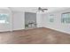 Spacious living room with hardwood floors, a ceiling fan, and a stylish stone fireplace at 3640 Silver Leaf Sw Ln, Marietta, GA 30008