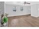 Bright living room features hardwood floors, large windows, and a charming stone fireplace at 3640 Silver Leaf Sw Ln, Marietta, GA 30008