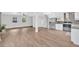 Open concept living space with tile floors adjacent to the modern kitchen at 3640 Silver Leaf Sw Ln, Marietta, GA 30008