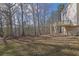 Expansive backyard featuring a two-level deck with stairs and wooded backdrop, perfect for outdoor entertaining at 917 Redstone Trl, Dacula, GA 30019