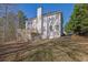 Spacious backyard featuring a two-story house with a deck and ample green space at 917 Redstone Trl, Dacula, GA 30019