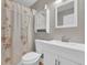 Bathroom featuring a floral shower curtain, updated vanity, and a decorative mirror at 917 Redstone Trl, Dacula, GA 30019