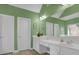 Bathroom with dual sinks, white cabinets, and a large mirror at 917 Redstone Trl, Dacula, GA 30019
