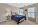 Cozy bedroom featuring a wrought iron bed frame, ample natural light, and neutral decor at 917 Redstone Trl, Dacula, GA 30019