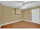 Neutral bedroom with wood floors, ceiling fan, and white trim at 917 Redstone Trl, Dacula, GA 30019