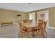 Cozy dining room with wood table and chairs, neutral walls, and tile flooring at 917 Redstone Trl, Dacula, GA 30019