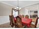 Formal dining room with elegant chandelier, ornate chairs, and a glimpse into the living area at 917 Redstone Trl, Dacula, GA 30019