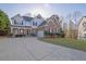 Attractive two-story home boasts a brick and siding exterior, attached garage, and manicured lawn at 917 Redstone Trl, Dacula, GA 30019