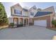 Desirable two-story home with brick and siding, attached two car garage, and lovely front yard at 917 Redstone Trl, Dacula, GA 30019