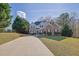 Charming two-story home features a brick and siding facade, well-maintained landscaping, and a long driveway at 917 Redstone Trl, Dacula, GA 30019