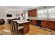 Open kitchen design with island seating, wood cabinets and black appliances, flowing into the living area at 917 Redstone Trl, Dacula, GA 30019