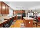 Traditional kitchen featuring wood cabinets, countertops, and a central island with bar stool seating at 917 Redstone Trl, Dacula, GA 30019